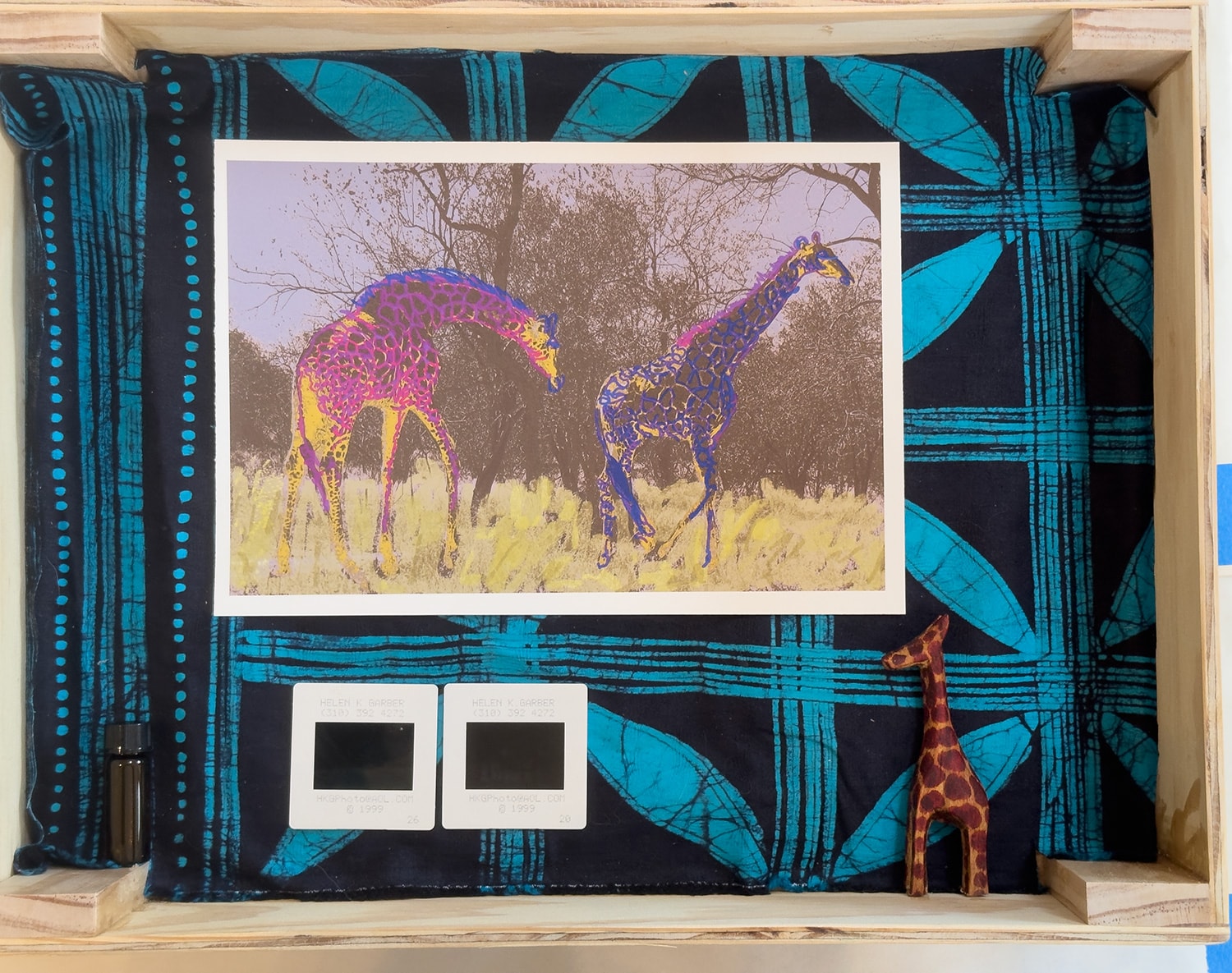 African Magic Box interior — colorized giraffe print on African mud cloth lining, mounted transparencies and carved wooden giraffe talisman — Helen K. Garber