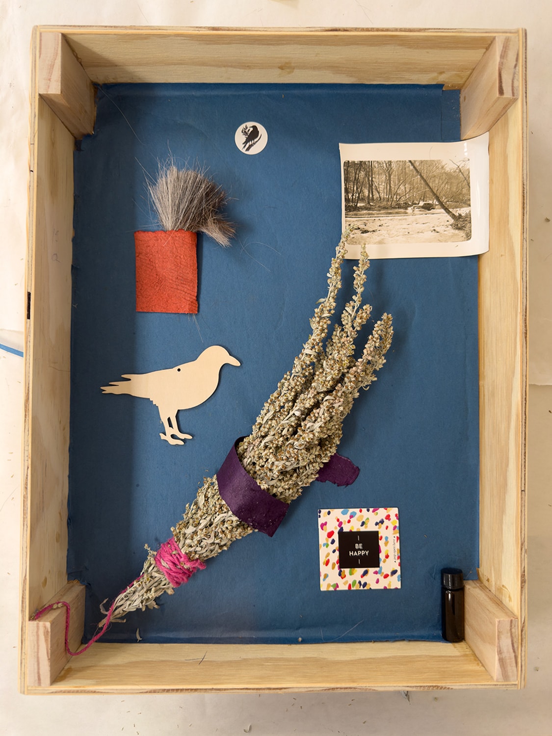 Magic Box interior — blue lining with wooden bird cutout, sage bundle, horse hair talisman, vintage photograph and essential oil vial — Helen K. Garber